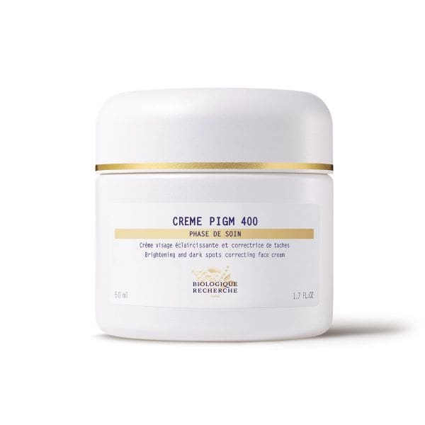 Biologique Recherche Crème PIGM 400 in a matte white round container with a matching lid, displayed on a clean white background. The jar features elegant gold detailing and blue lettering on the branded label. A brightening face cream formulated to reduce the appearance of dark spots, even skin tone, and enhance radiance.